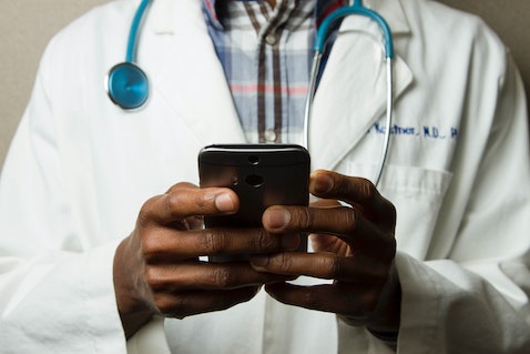 doctor looking at phone