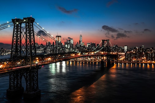 new york skyline at night with bridge
