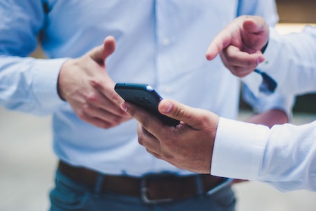 person using phone to access pay portal