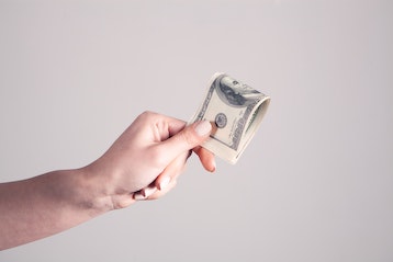 person holding cash in hand
