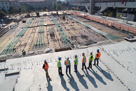 construction workers overseeing building site